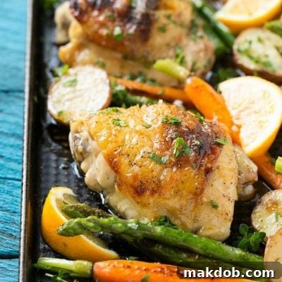 This recipe for lemon thyme chicken is a one pan meal of tender chicken thighs, new potatoes and spring vegetables, all seasoned with a sweet and savory butter and roasted to perfection.