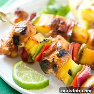 Juicy Hawaiian Chicken Kabobs with pineapple, bell peppers, and onion, marinated in a sweet and tangy sauce, grilled to perfection.