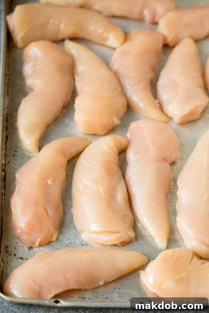 Cornflake Chicken Recipe | Chicken Fingers #chicken #dinner #dinneratthezoo Chicken breast tenders on a sheet pan.