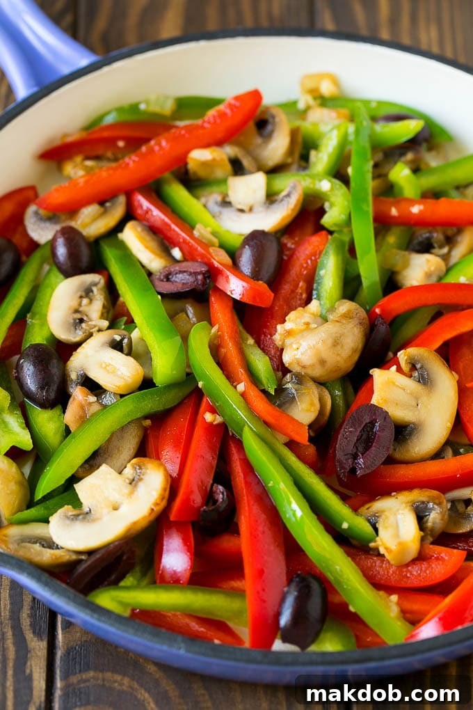 Chicken Cacciatore Recipe | Italian Chicken #chicken #peppers #mushrooms #olives #dinner #dinneratthezoo A vibrant mix of sliced bell peppers, mushrooms, and Kalamata olives sautéing in a pan, releasing their aromas.