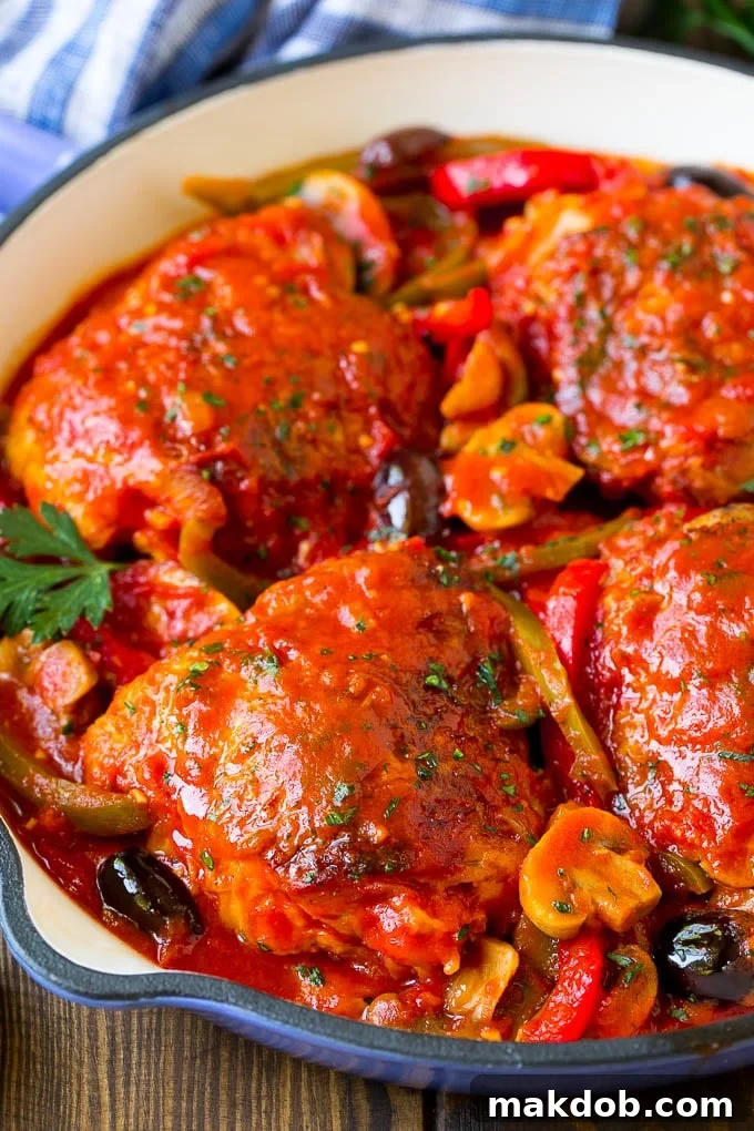 Chicken Cacciatore Recipe | Italian Chicken #chicken #peppers #mushrooms #olives #dinner #dinneratthezoo Chicken cacciatore simmering in a large skillet, showcasing the rich tomato sauce, tender chicken, and colorful vegetables.