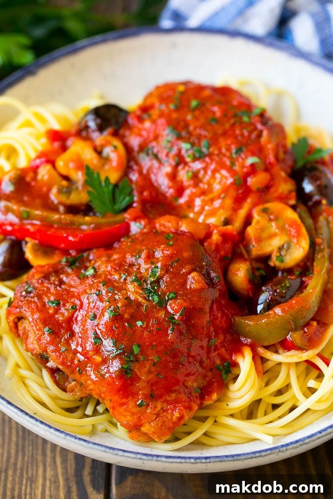 Chicken Cacciatore Recipe | Italian Chicken #chicken #peppers #mushrooms #olives #dinner #dinneratthezoo Tender braised chicken cacciatore served elegantly over a bed of spaghetti, garnished with fresh parsley.