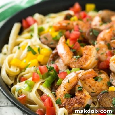 Bayou-Spiced Shrimp & Andouille Pasta 2 This recipe for Cajun shrimp and sausage pasta is sauteed shrimp and smoked sausage with colorful vegetables, all served over a creamy fettuccine pasta. Dinner's ready in less than 30 minutes with plenty of bold flavors!