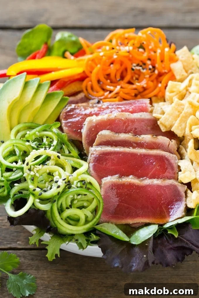 Seared Ahi Tuna Salad with Zesty Sesame Ginger Vinaigrette 2 Ahi tuna salad with cucumbers, carrots and wonton strips in a sesame dressing.