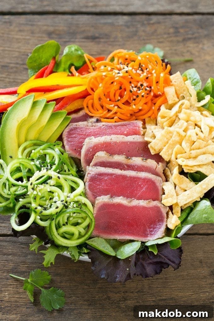 Seared Ahi Tuna Salad with Zesty Sesame Ginger Vinaigrette 5 A bed of greens with seared tuna, carrots, cucumber and wonton strips.