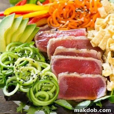 Seared Ahi Tuna Salad with Zesty Sesame Ginger Vinaigrette 6 This recipe for ahi tuna salad is seared ahi on a bed of mixed greens with cucumber and carrot noodles, bell peppers, avocado and wontons, all tossed in a sesame ginger dressing. #BBSuperFresh #Seafoodies