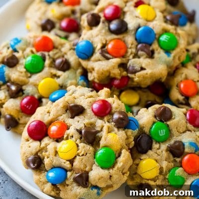 A plate of monster cookies which are made with oats, peanut butter, chocolate chips and M&M's.
