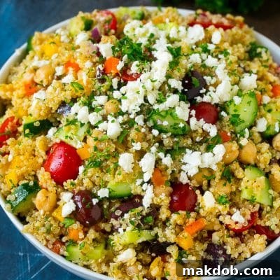Quinoa salad with tomatoes, cucumbers, peppers, onions and olives.