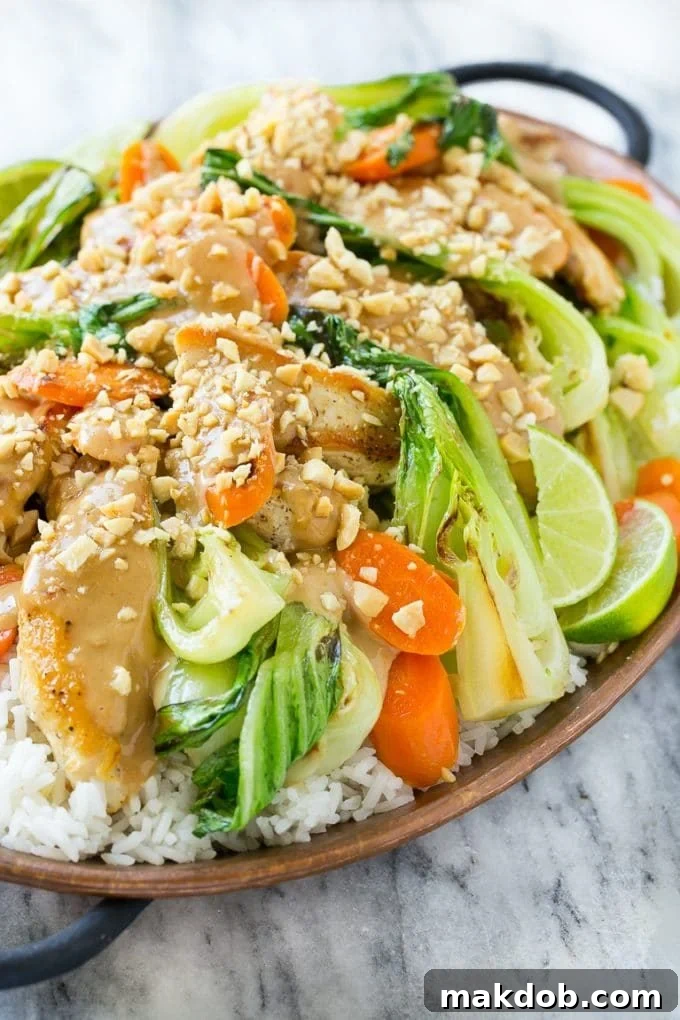 Simple & Flavorful Thai Chicken with Peanut Sauce Chicken and vibrant vegetables generously coated in a rich, homemade peanut sauce, showcasing the dish's appealing texture.
