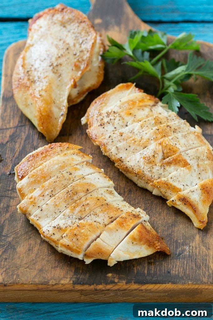 Chicken Primavera Recipe | Chicken Pasta | Vegetable Pasta #chicken #pasta #asparagus #carrots #peas #spring #dinner #dinneratthezoo Sliced cooked chicken breasts neatly arranged on a cutting board, ready for the pasta dish.