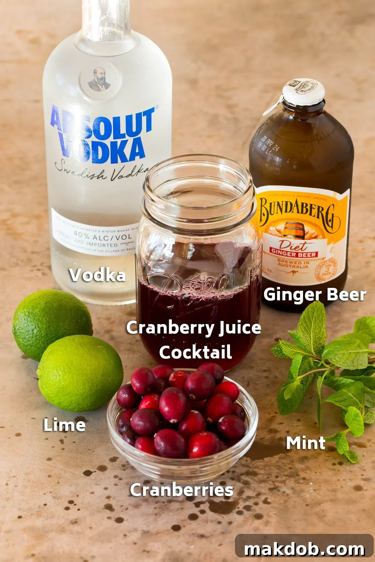 Ingredients including a bottle of vodka, ginger beer and cranberry juice.