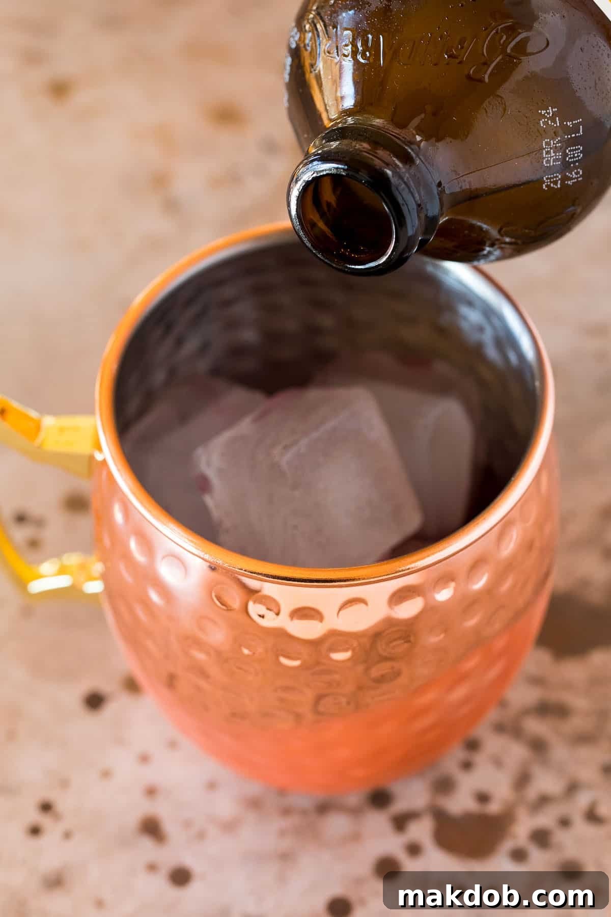 Ginger beer being poured into a mug.