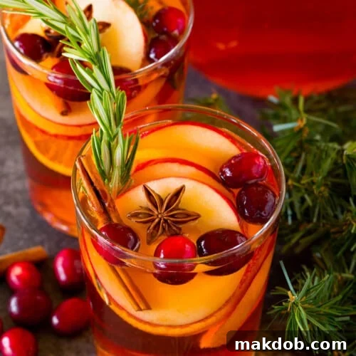 Jolly Christmas Sangria 7 Glasses of Christmas sangria garnished with fresh fruit, cinnamon and rosemary.