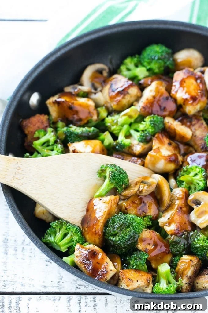 Chicken and Broccoli Stir Fry Recipe | Chicken Stir Fry | Healthy Chicken Recipe | Chicken and Broccoli | Chinese Food A stir fry of chicken, broccoli and mushrooms in a skillet with a spatula.
