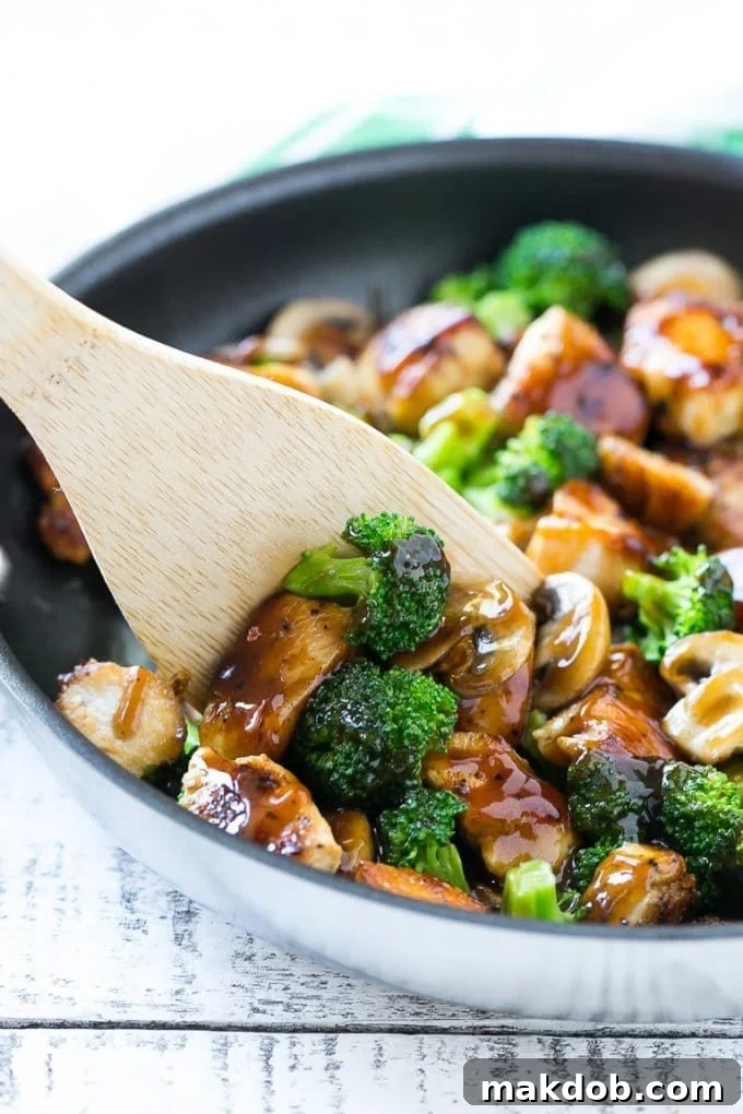 Chicken and Broccoli Stir Fry Recipe | Chicken Stir Fry | Healthy Chicken Recipe | Chicken and Broccoli | Chinese Food A spatula scooping chicken stir fry out of a pan.