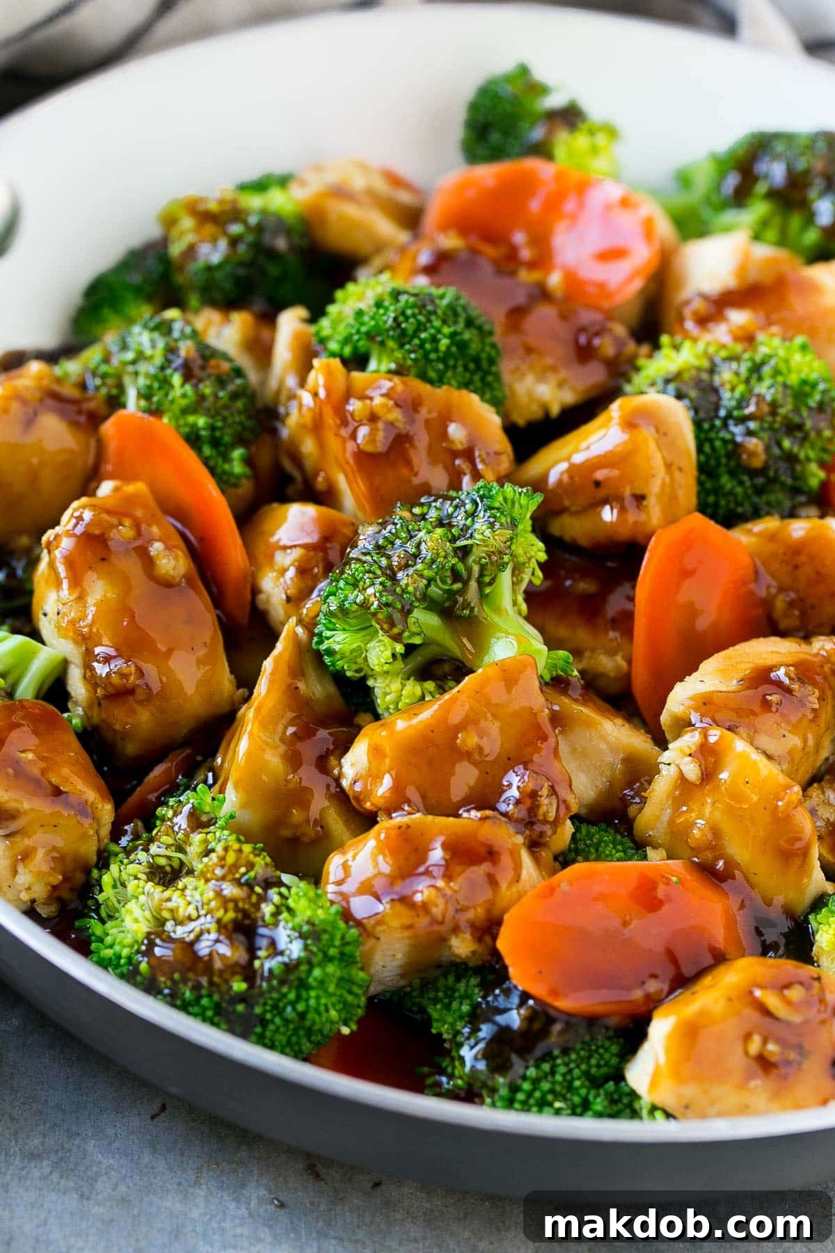 A vibrant stir-fry dish featuring succulent chicken and colorful vegetables, generously coated with the homemade stir fry sauce, ready to be enjoyed.