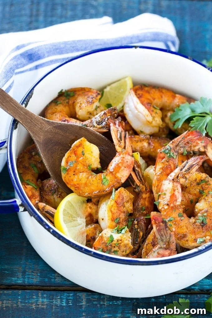 New Orleans BBQ Shrimp | Barbecue Shrimp #shrimp #seafood #dinner #appetizer #dinneratthezoo Delicious BBQ shrimp simmering in a spiced butter sauce within a sturdy pot, ready for serving.