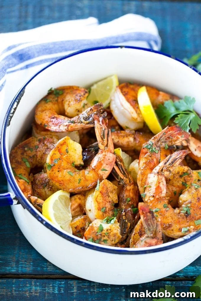 New Orleans BBQ Shrimp | Barbecue Shrimp #shrimp #seafood #dinner #appetizer #dinneratthezoo Giant shrimp cooked in a spiced butter sauce, elegantly garnished with fresh lemon slices and finely chopped parsley.