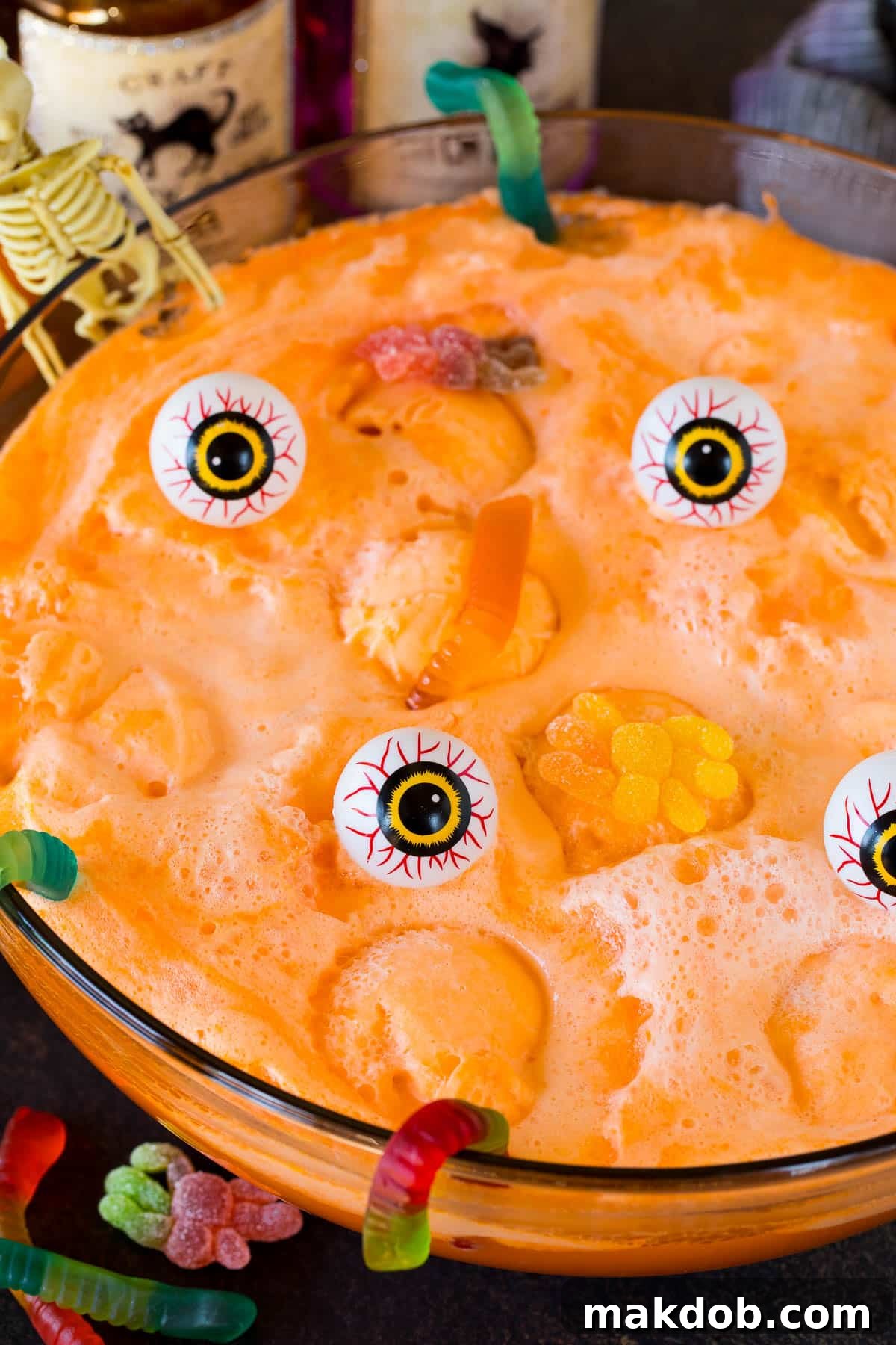Enchanted Concoction 6 A bowl of witches brew garnished with gummy spiders, gummy worms and plastic eyeballs.