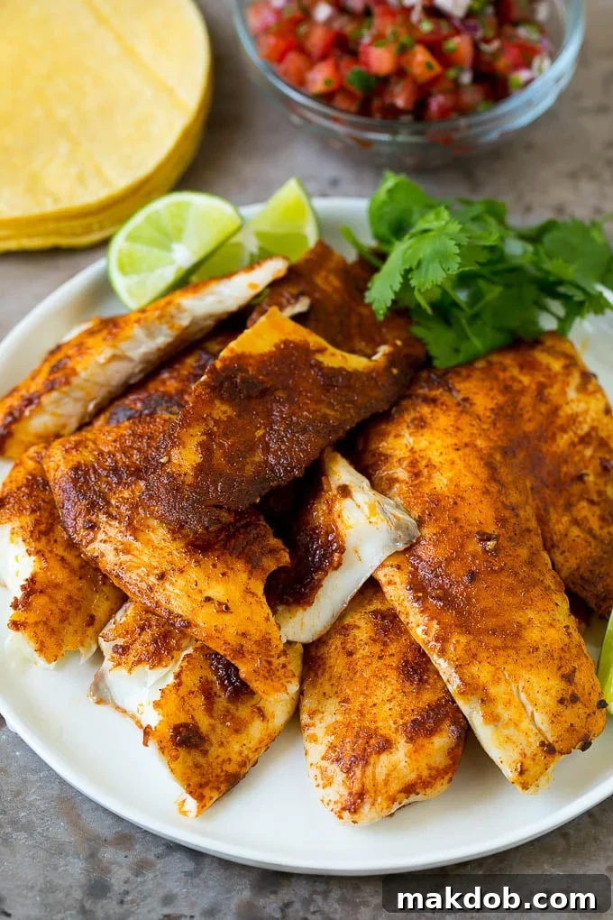 Fish Tacos Recipe | Tilapia Fish Tacos #tacos #fish #tacotuesdady #avocado #dinner #dinneratthezoo A plate of taco seasoned fish fillets with a lime and cilantro garnish.