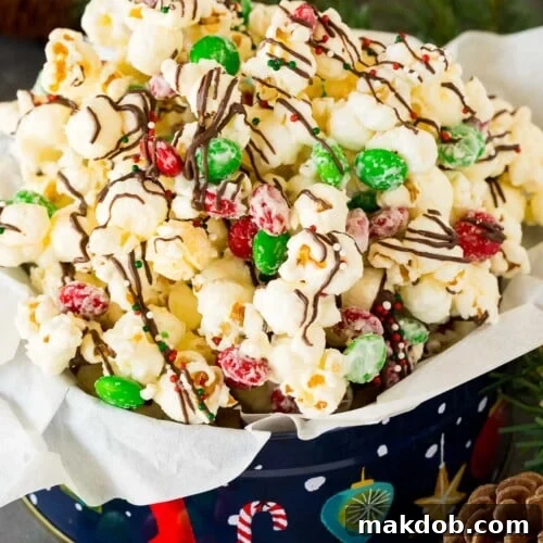 A gift tin filled with Christmas popcorn.