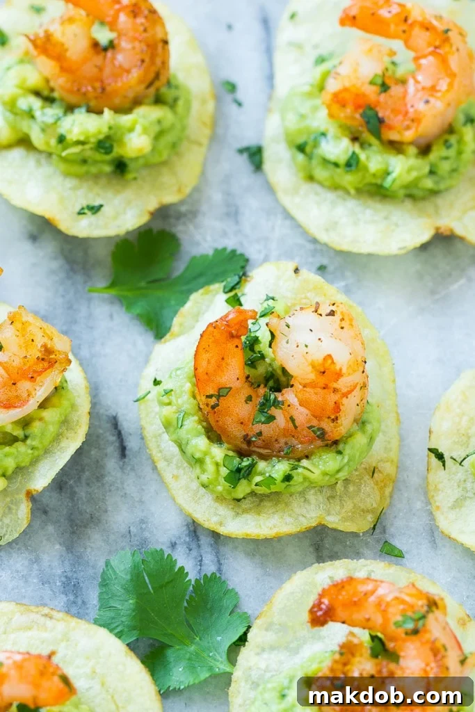 Individual potato chips generously topped with creamy guacamole and a perfectly seared, chili-spiced shrimp.