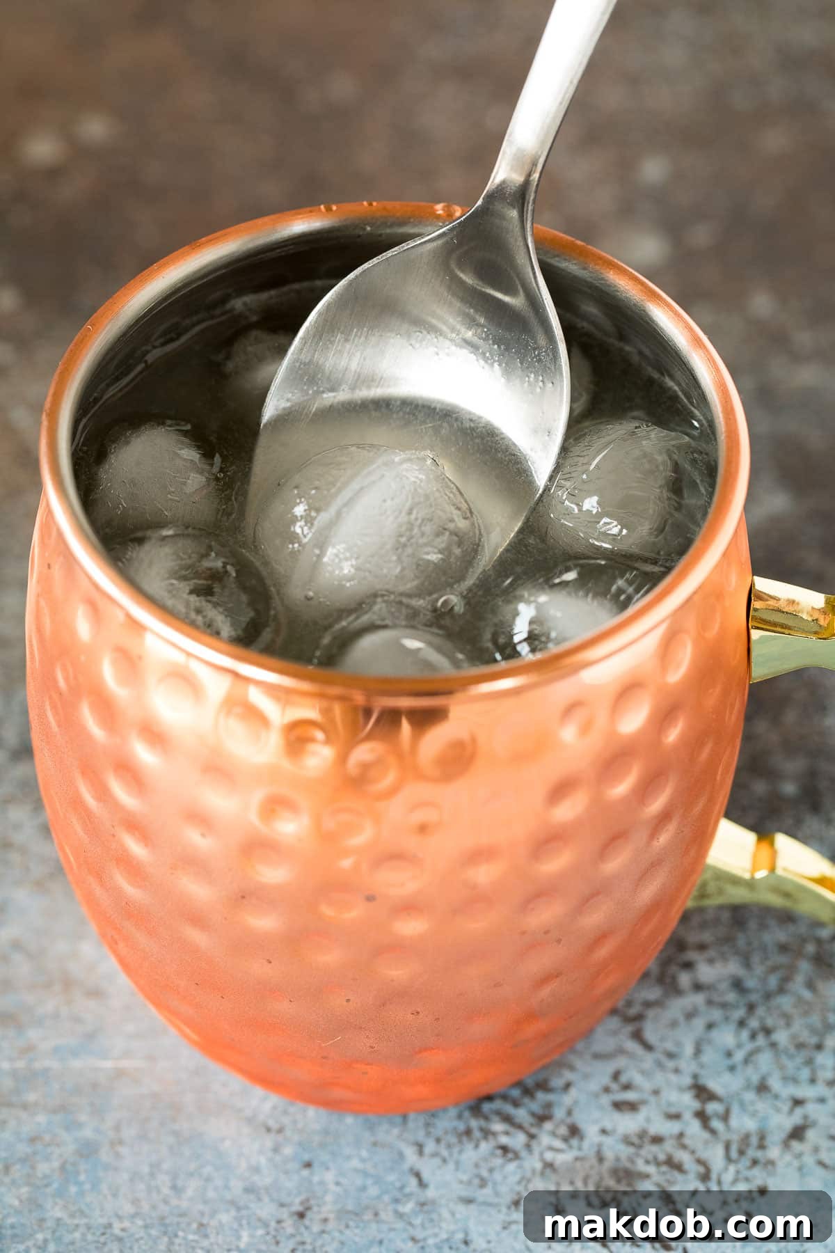 Tequila Mule 5 A spoon stirring a mule drink.