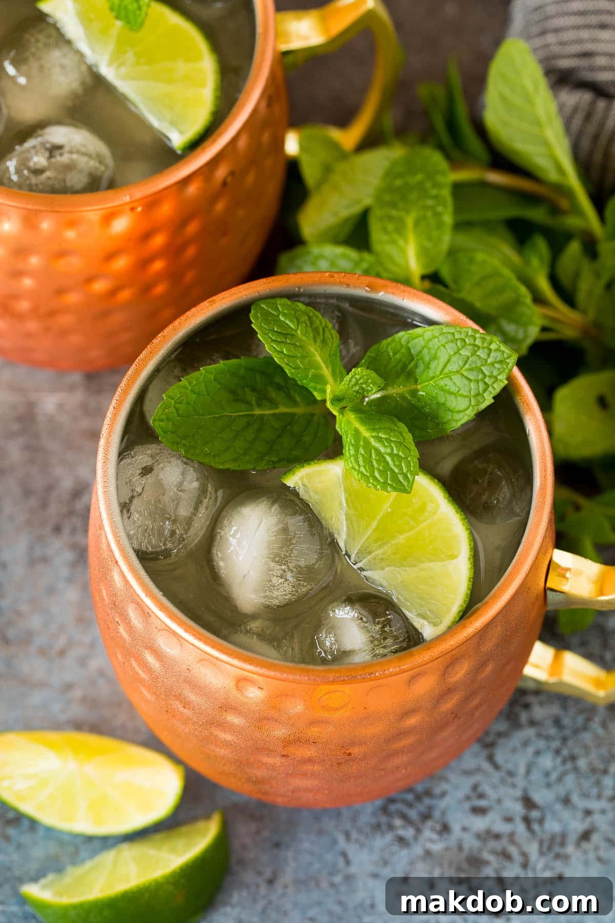 Tequila Mule 6 Two Mexican mule drinks garnished with lime wedges and mint sprigs.