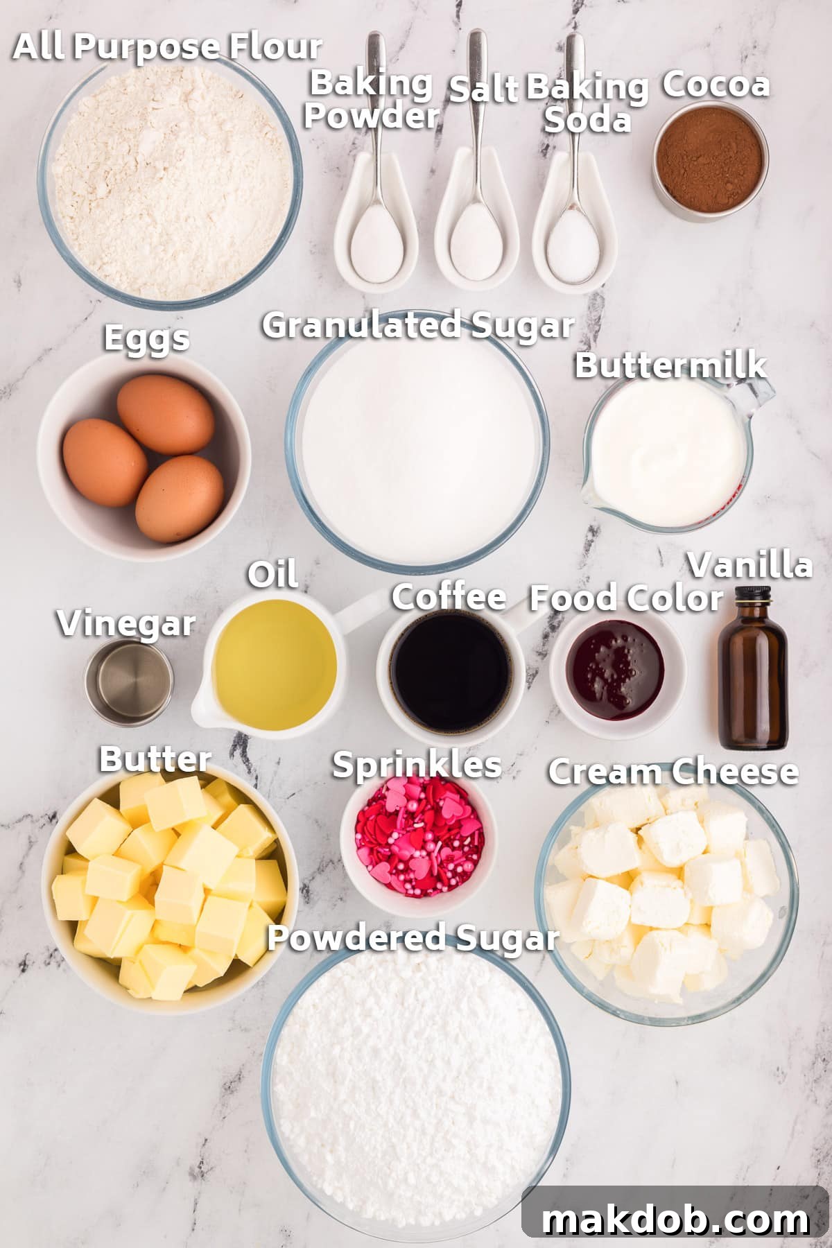 A collection of essential baking ingredients arranged on a countertop, including butter, flour, sugar, cream cheese, and colorful sprinkles, ready for making a delicious heart cake.
