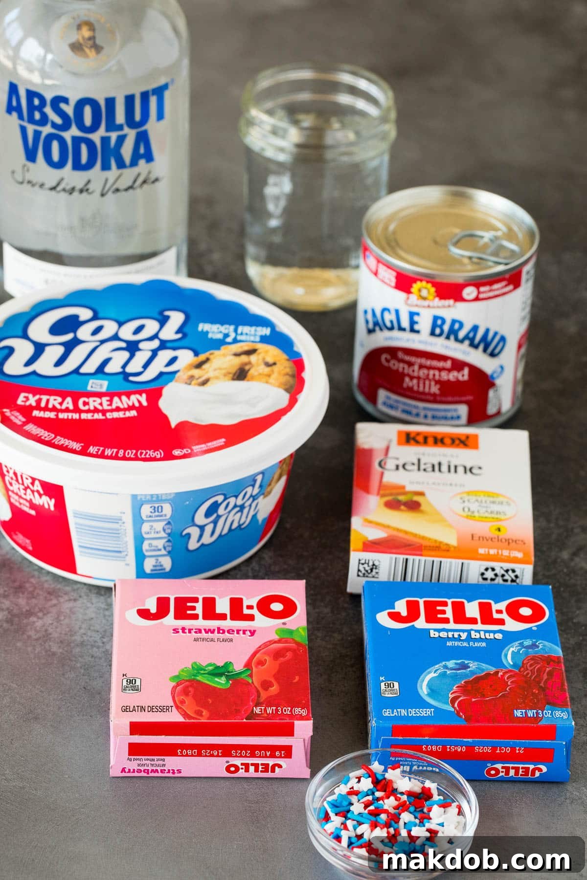 Star-Spangled Jell-O Shooters 3 Ingredients for red white and blue Jello shots including gelatin boxes, vodka, and water.