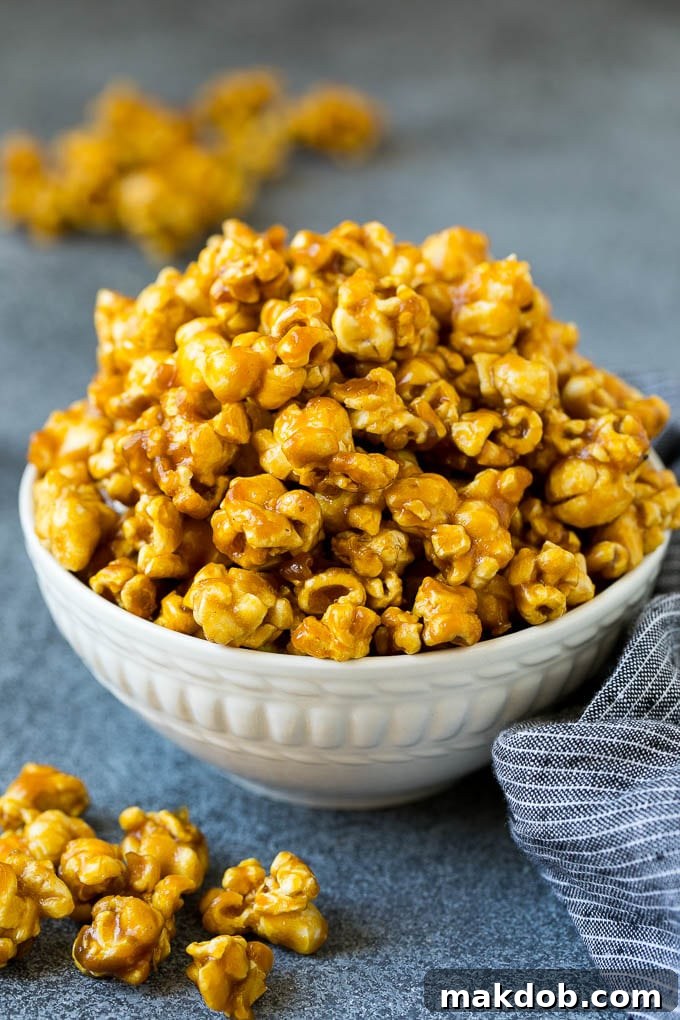 A serving bowl filled with golden, sticky caramel popcorn, ready to be enjoyed.