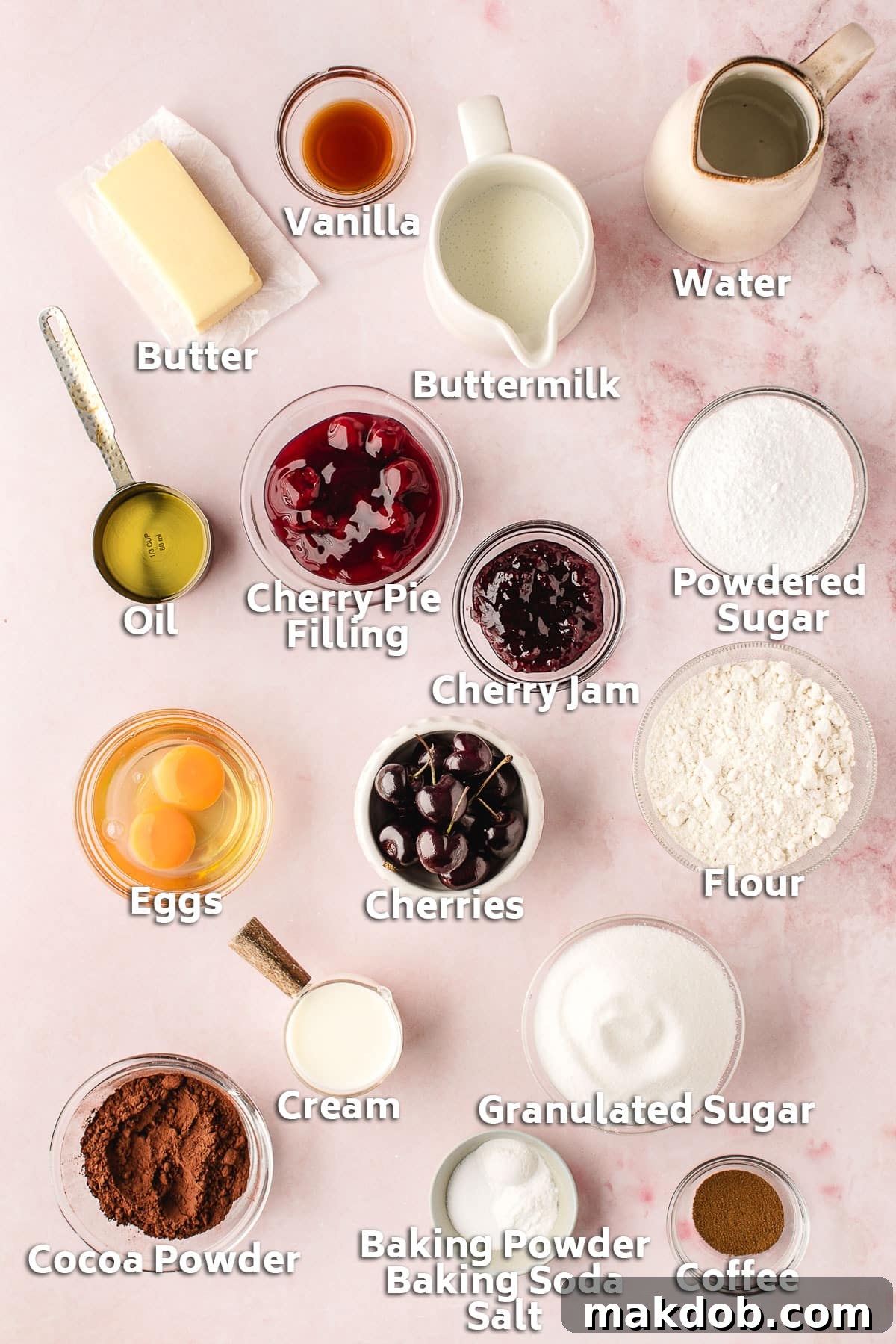 Various baking ingredients for Black Forest Cupcakes, including butter, flour, sugar, cocoa powder, and cherry jam, displayed in bowls.