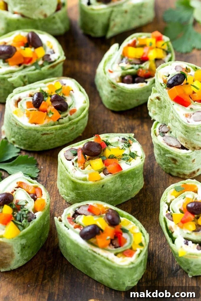 Mexican Tortilla Pinwheels | Mexican Pinwheels #pinwheels #sandwiches #tortilla #snack #dinneratthezoo Mexican tortilla pinwheels with cheese, beans, bell peppers and cilantro.
