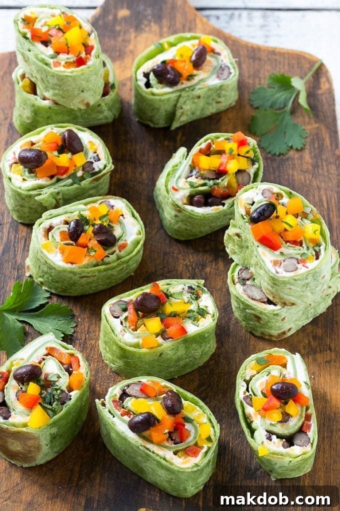 Mexican Tortilla Pinwheels | Mexican Pinwheels #pinwheels #sandwiches #tortilla #snack #dinneratthezoo Tortilla pinwheels with a filling of cream cheese, black beans, bell peppers and seasonings.