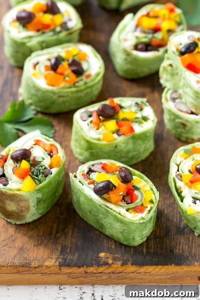 Mexican Tortilla Pinwheels | Mexican Pinwheels #pinwheels #sandwiches #tortilla #snack #dinneratthezoo Mexican pinwheel sandwiches with cheese, beans, colored bell peppers and seasonings.