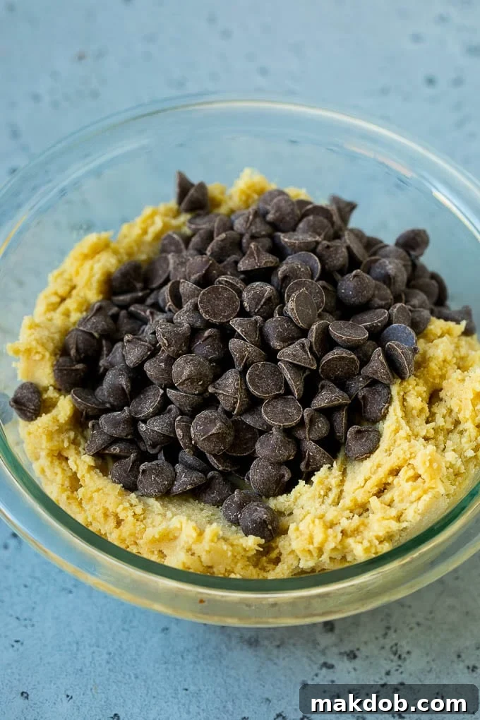Preparing Chocolate Chip Cookie Dough for Baking A mixing bowl filled with rich, ready-to-bake chocolate chip cookie dough, promising a delightful dessert.