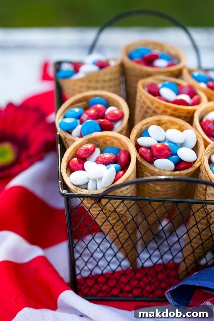 Ice cream cones filled with colorful Red, White & Blue M&M's, perfect as individual party treats.