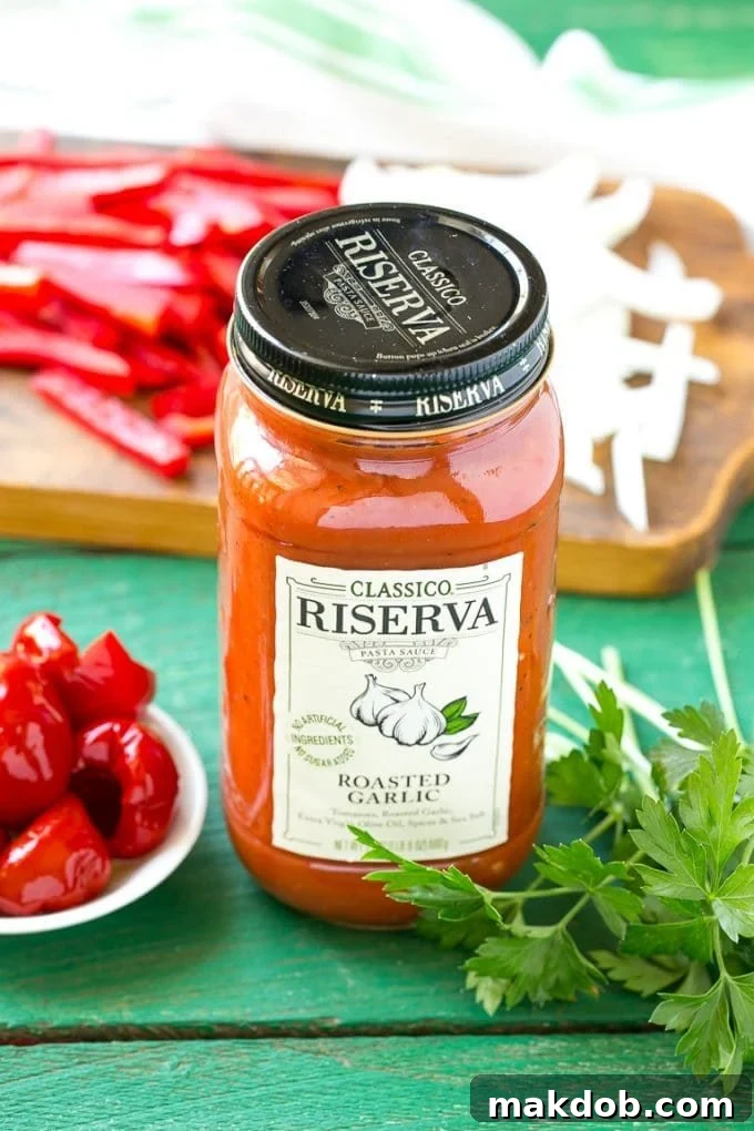 A jar of Classico Riserva Roasted Garlic pasta sauce, a key ingredient for rich tomato sauces.