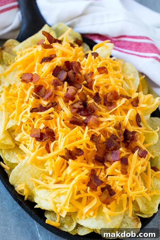 Irish Nachos Recipe | Potato Nachos | Potato Chip Recipe | Appetizer Recipe #nachos #potatoes #cheese #bacon #appetizer #dinneratthezoo Kettle chips topped with shredded cheese and bacon.