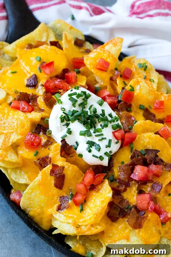 Irish Nachos Recipe | Potato Nachos | Potato Chip Recipe | Appetizer Recipe #nachos #potatoes #cheese #bacon #appetizer #dinneratthezoo A skillet of Irish nachos topped with melted cheese, bacon, tomatoes and sour cream.