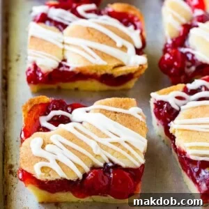 Cherry bars made with almond cookie dough on a sheet pan.