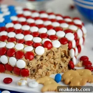 An image of a cake decorated like an American flag and filled with cookie dough.