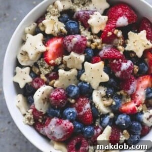 An image of fruit salad with quinoa and red, white and blue fruits.