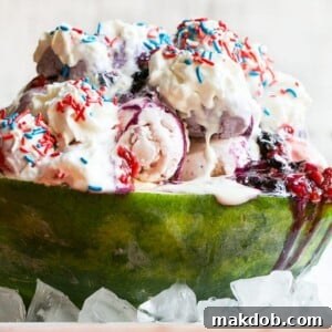 This recipe for a Red White and Blueberry Sundae is a watermelon loaded with three types of ice cream, homemade strawberry and blueberry sauces, marshmallow topping and the whole thing is finished off with whipped cream, sprinkles and chocolate covered strawberries. It's the perfect show stopper for the 4th of July!