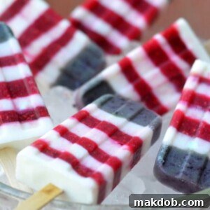 Refreshing Red, White, and Blueberry Yogurt Popsicles, a healthy and patriotic summer treat.