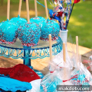 An image of a group of blue candy coated apples with red and white sprinkles.