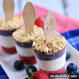 A festive red, white, and blue cheesecake popsicle, perfect for cooling down on a hot summer day.
