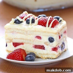 A delicious slice of No Bake Summer Berry Icebox Cake, featuring vibrant layers of berries and cream.