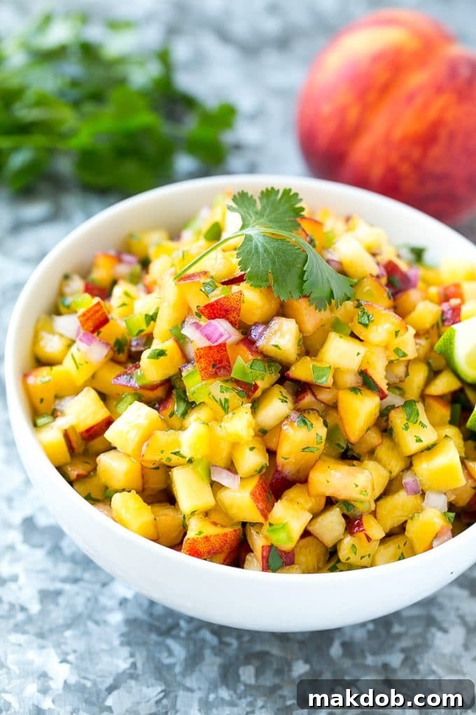 Peach salsa in a bowl made with red onion, jalapeno and cilantro.