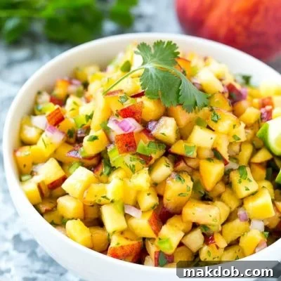 This recipe for peach salsa is the ultimate summer condiment. Juicy ripe peaches, herbs, and a bit of jalapeno creates a sweet and spicy salsa that's perfect with chips, on fish or chicken, or even on a sandwich! #adv